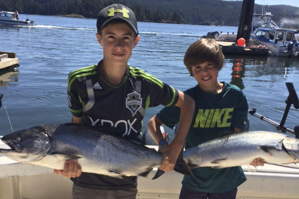 Young men with large fish